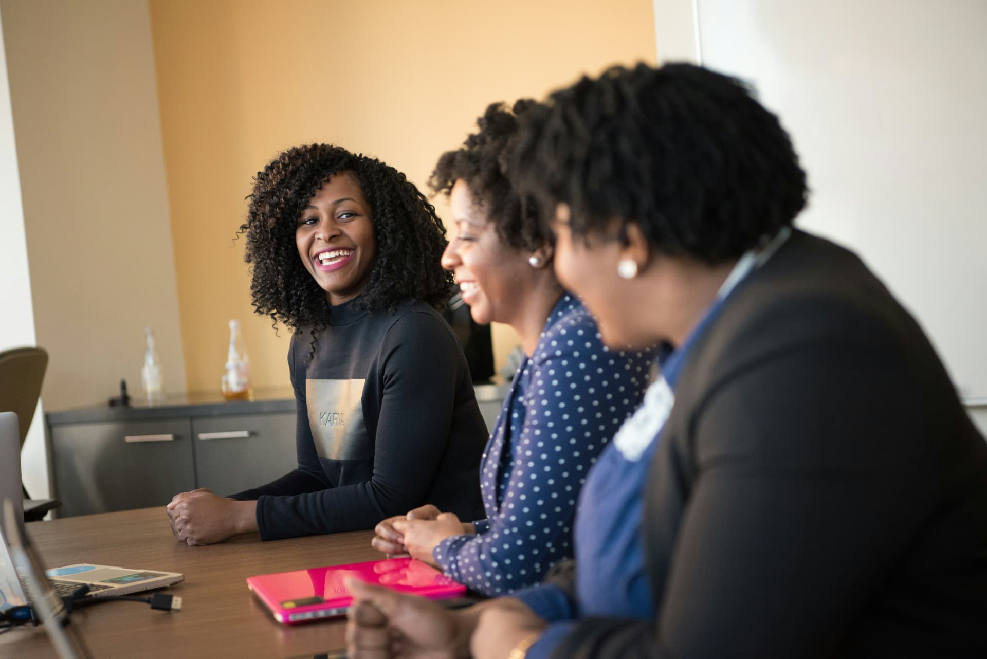 Colleagues in conversation around a meeting table
